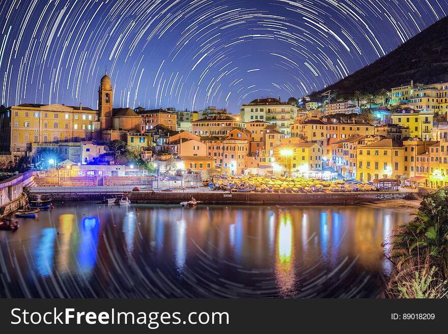 Port of Genova Nervi at night, star trails in the background. Port of Genova Nervi at night, star trails in the background.
