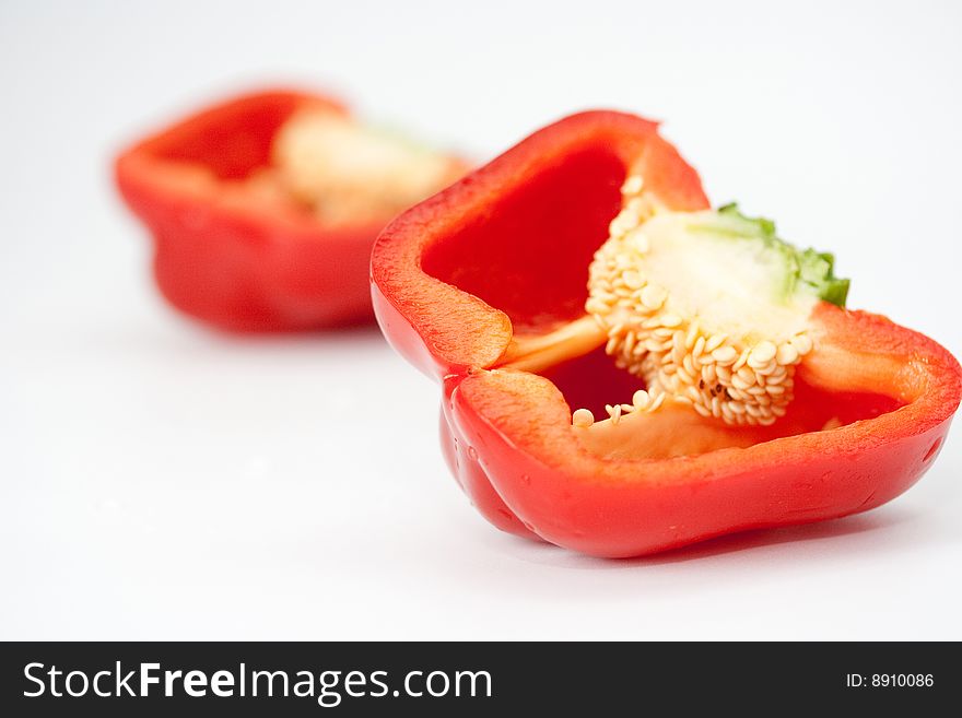 The cut red sweet pepper with seeds
