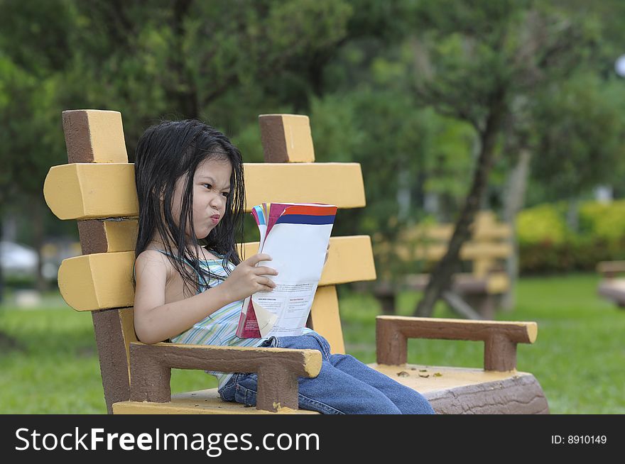 Cute little girl reading a book