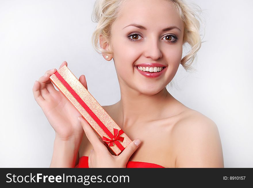 Young blond girl with present close up shoot