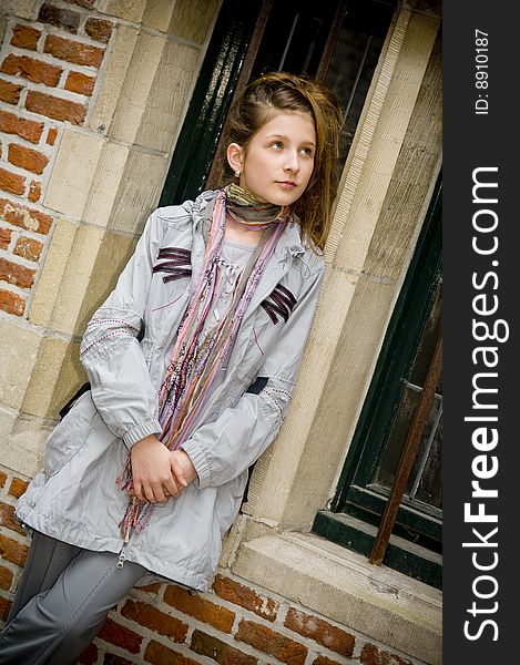 Trendy fashion teenager girl showing off new clothes against street background