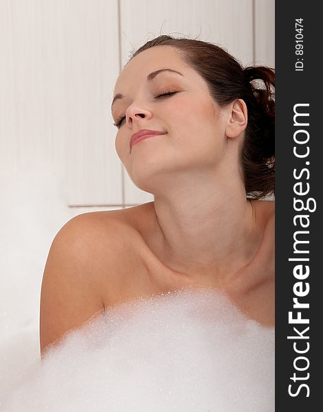 Body care - Young woman in the bathtub with foam. Body care - Young woman in the bathtub with foam