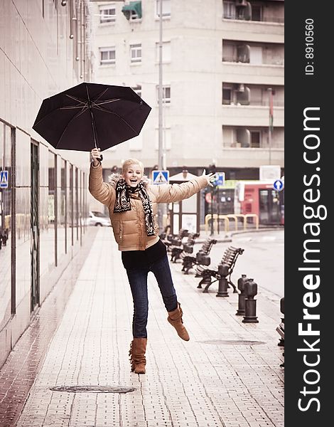Happy young blond woman in a rainy day. Happy young blond woman in a rainy day.