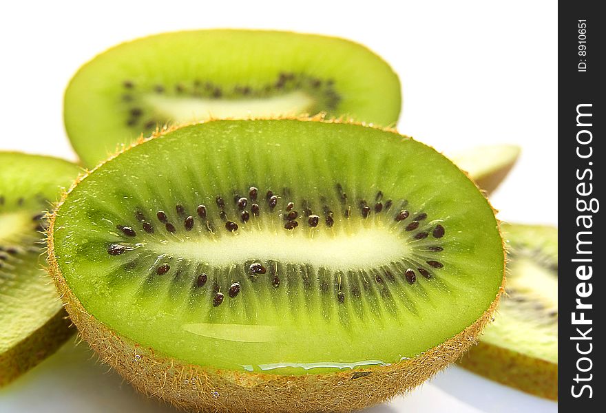 Ripe segment kiwi with drops of juice, on a white background