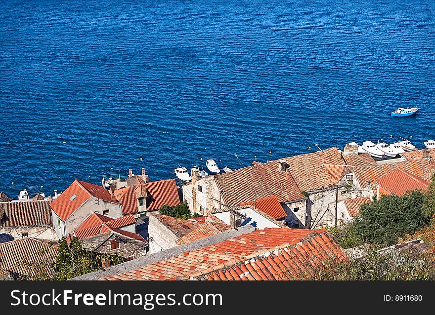 View of a Mediterranean Sea with roofs in foreground. View of a Mediterranean Sea with roofs in foreground