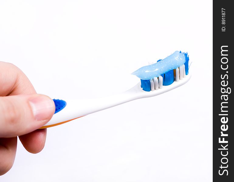 Toothbrush with blue transparent toothpaste at white background. Toothbrush with blue transparent toothpaste at white background