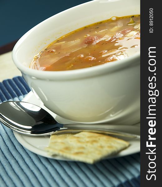 Bowl of soup with spoon and cookie. Bowl of soup with spoon and cookie