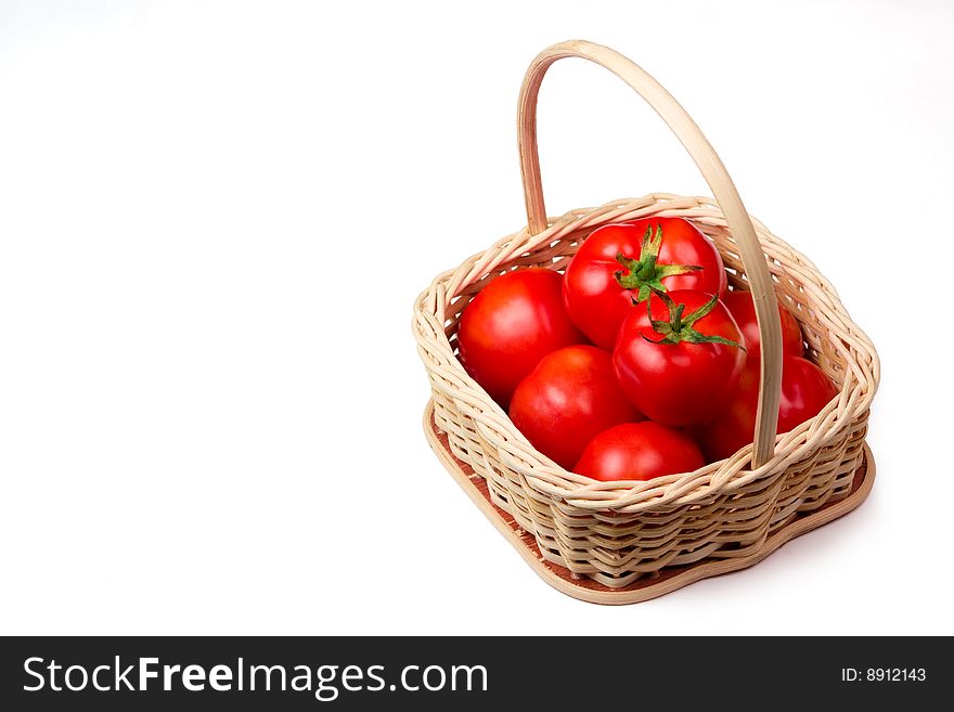 Fresh tomato  in a basket isolated on white background. Fresh tomato  in a basket isolated on white background