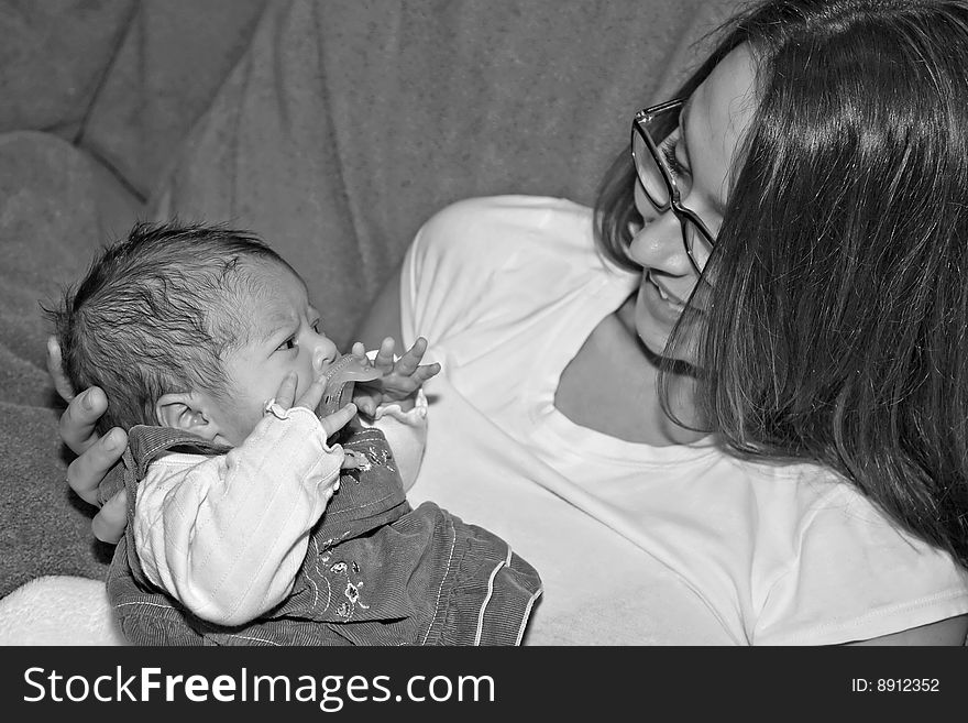 Young woman holding small newborn infant girl. Young woman holding small newborn infant girl