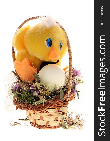 Toy chicken sits near the egg in the basket. Toy chicken sits near the egg in the basket