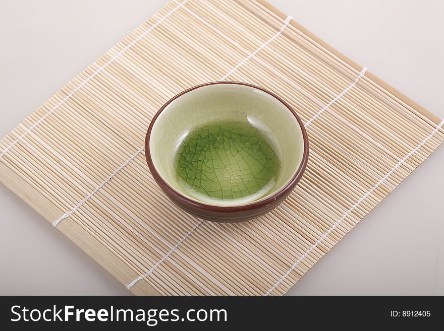 A Bamboo Mat And Round Bowl