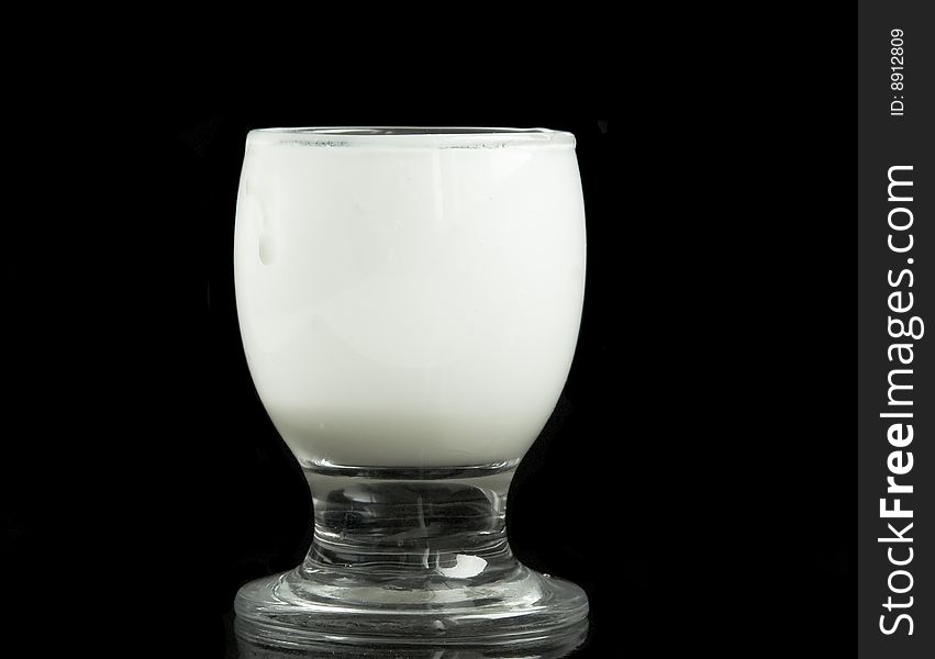 Glass with milk on a black background. Glass with milk on a black background