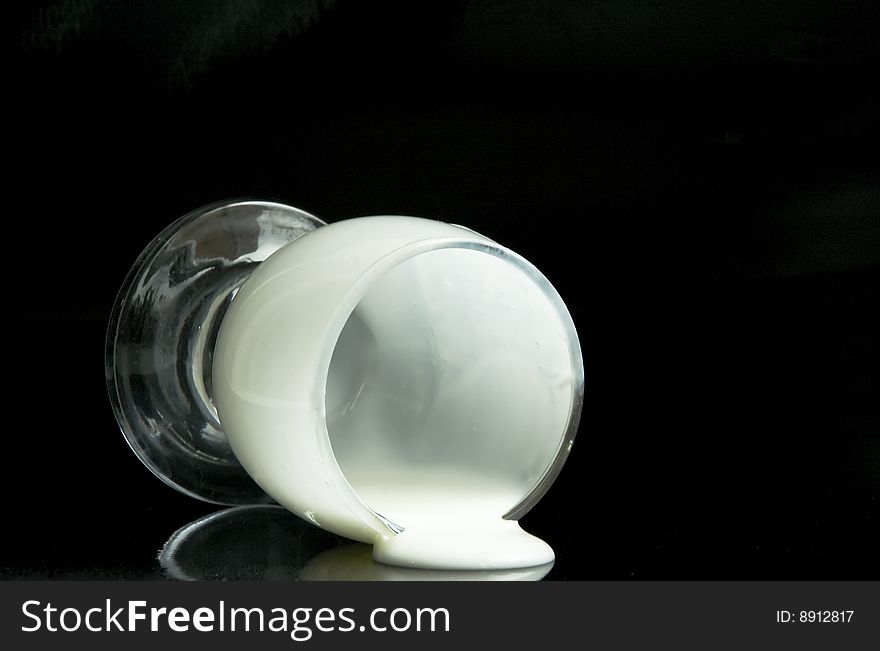 Glass with milk on a black background. Glass with milk on a black background