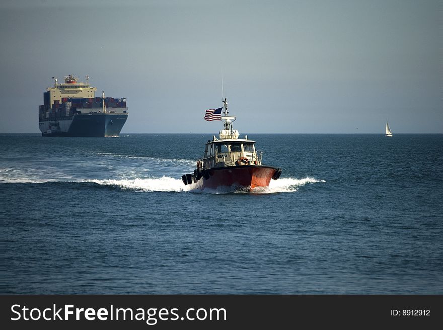 The harbor pilot returns to port after meeting a container ship. The harbor pilot returns to port after meeting a container ship.