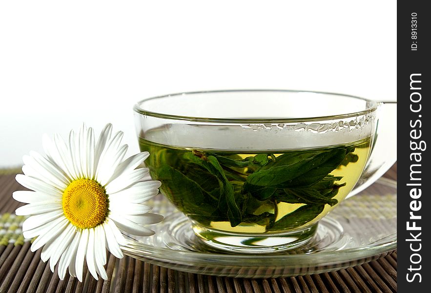 Cup of herbal tea and flower of a chamomile. Cup of herbal tea and flower of a chamomile