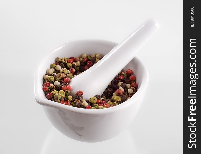 Mix of peppercorns in a porcelain mortar