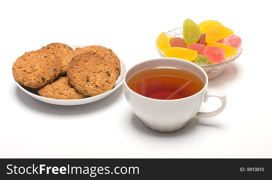 Tea colour fruit candy and cookies close up. Tea colour fruit candy and cookies close up