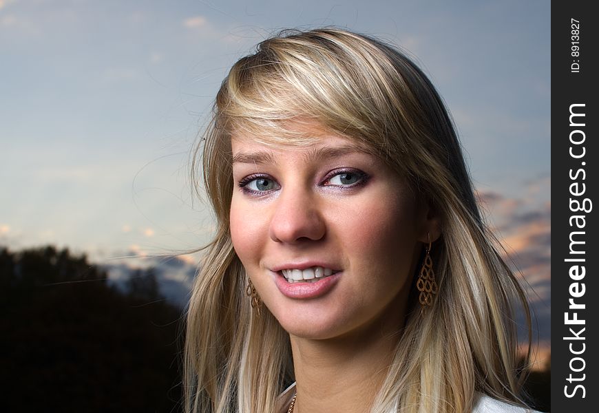 Pretty girl face portrait with soft blue sky on background