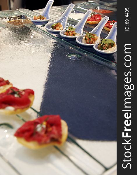 Gourmet canapes on square glass serving tray. Gourmet canapes on square glass serving tray