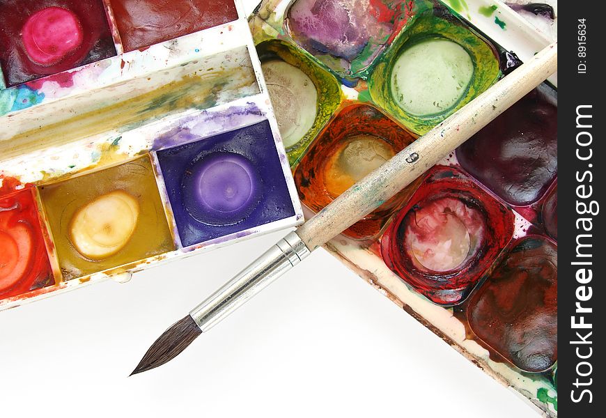 Dirty watercolor paints set with brush after using. Dirty watercolor paints set with brush after using