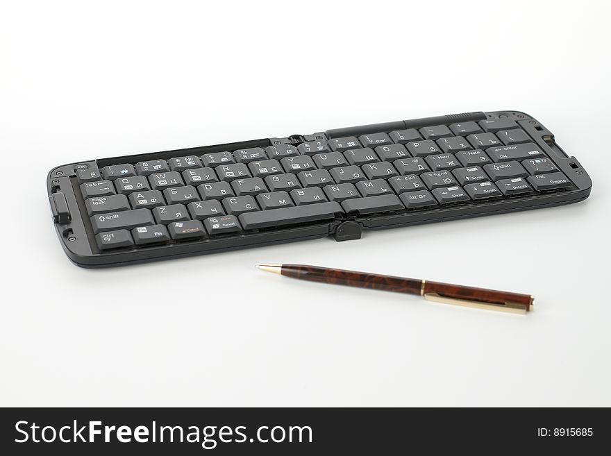 Compact black keyboard for mobile telephone and pen. Compact black keyboard for mobile telephone and pen