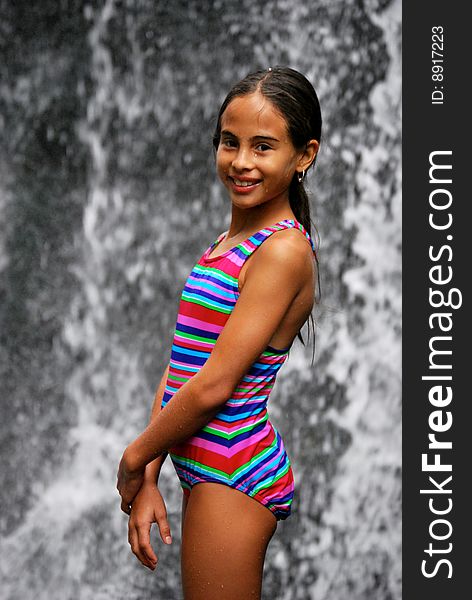 Beautiful Hispanic girl in front of a waterfall. Beautiful Hispanic girl in front of a waterfall.