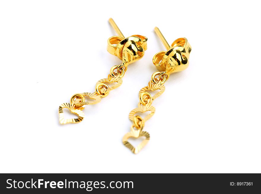 A pair of golden earrings isolated on white background.