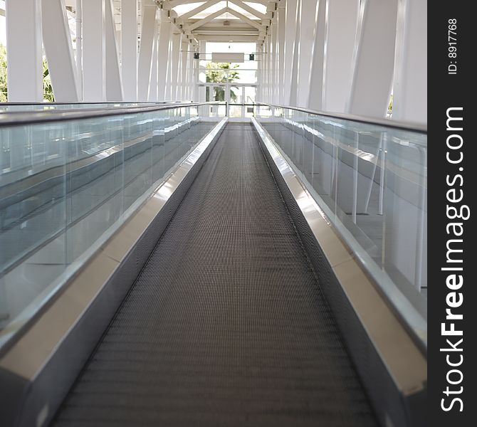 A long, empty moving walkway for pedestrians.