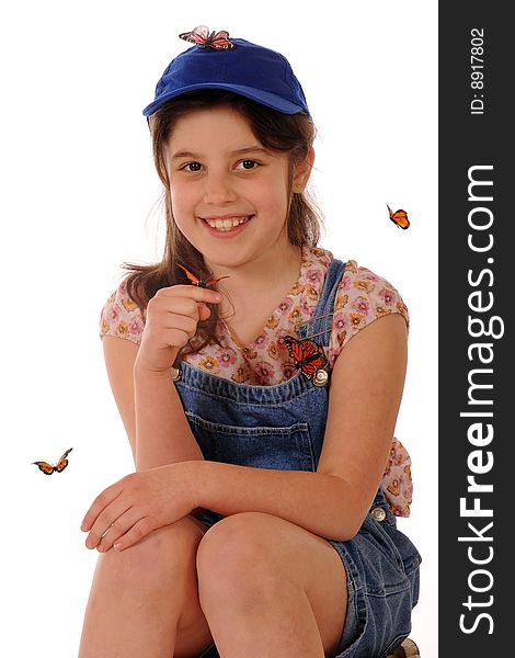 A portriat of a cute elementary girl with a monarch butterfly on her finger and others flying around or on her.  Isolated on white. A portriat of a cute elementary girl with a monarch butterfly on her finger and others flying around or on her.  Isolated on white.