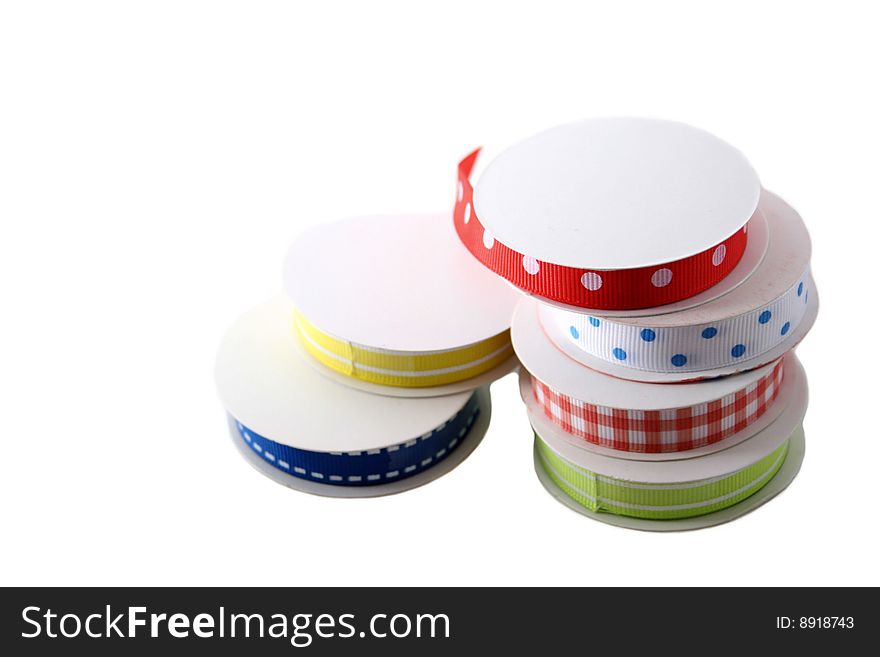 Several spools of colorful ribbon isolated on white. Several spools of colorful ribbon isolated on white