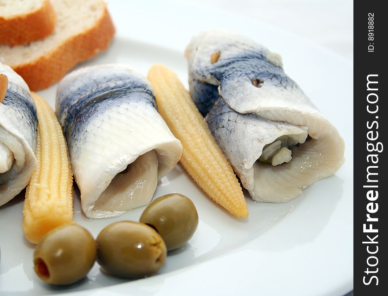 Some fresh fish with olives and corn