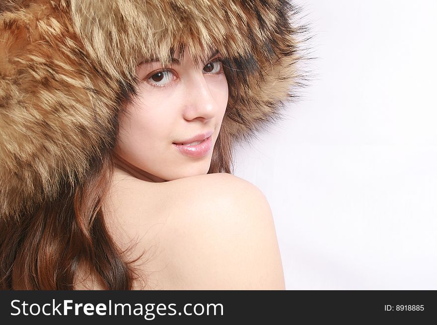 Portrait of the beautiful girl in a fur cap close up. Portrait of the beautiful girl in a fur cap close up.