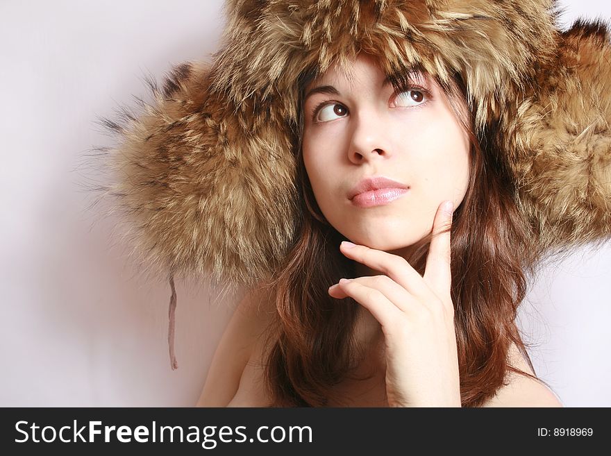 Portrait of the beautiful girl in a fur cap close up. Portrait of the beautiful girl in a fur cap close up.