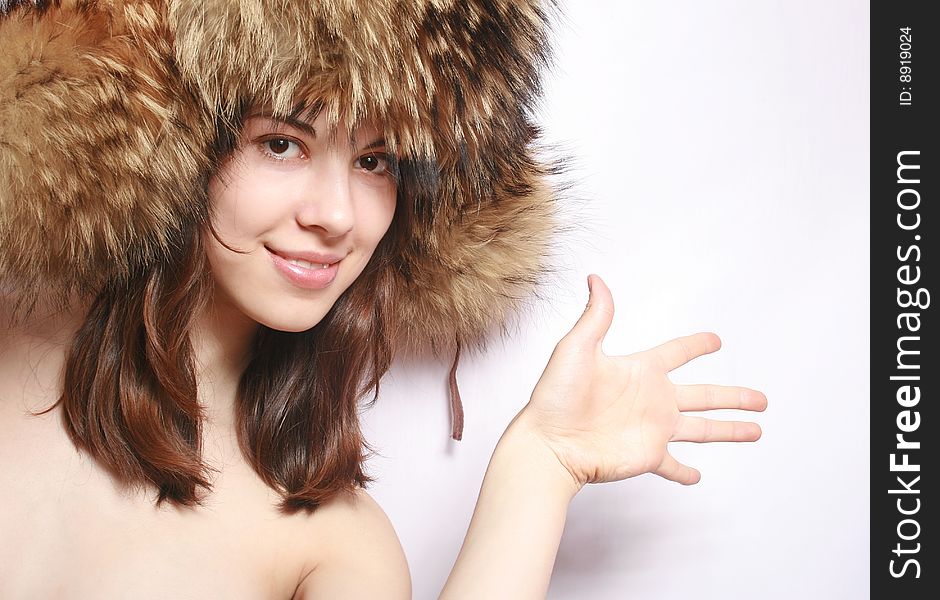 Portrait of the beautiful girl in a fur cap close up. Portrait of the beautiful girl in a fur cap close up.