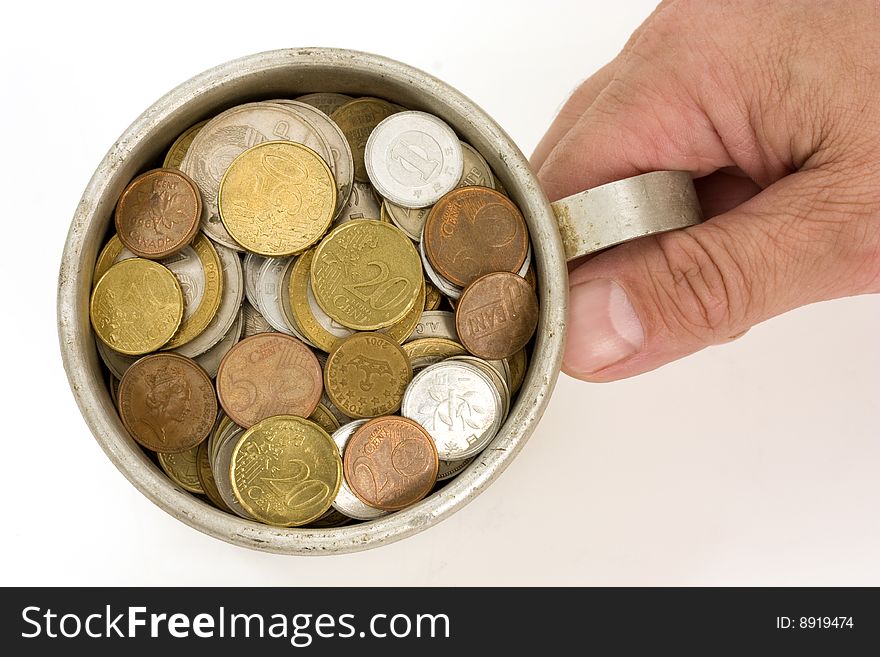 The Male hands and aluminum mug with money. The Male hands and aluminum mug with money.