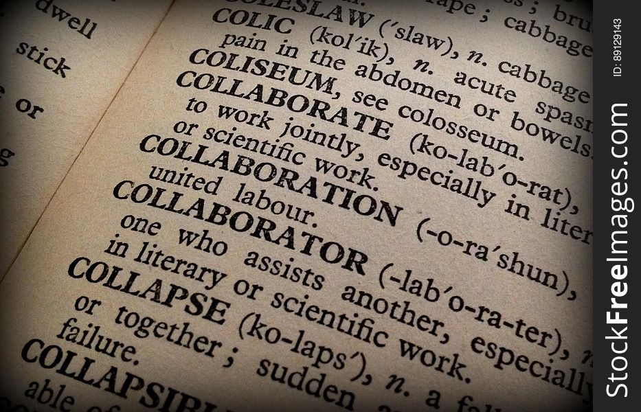 A dictionary open at the word "collaboration".
