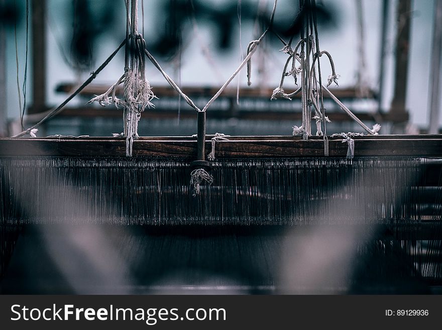 A view inside a loom used in weaving fabrics. A view inside a loom used in weaving fabrics.