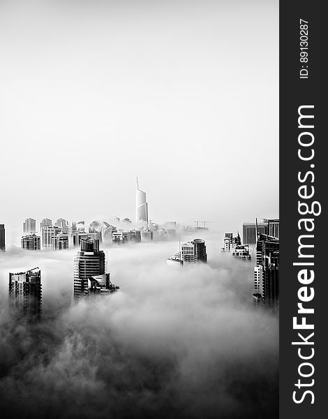 A black and white photo of the city of Dubai covered in clouds. A black and white photo of the city of Dubai covered in clouds.