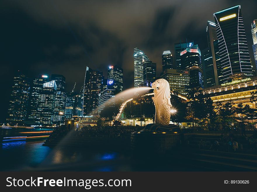 The Merlion statue in The Merlion Park with the Singapore skyline in the background. The Merlion statue in The Merlion Park with the Singapore skyline in the background.