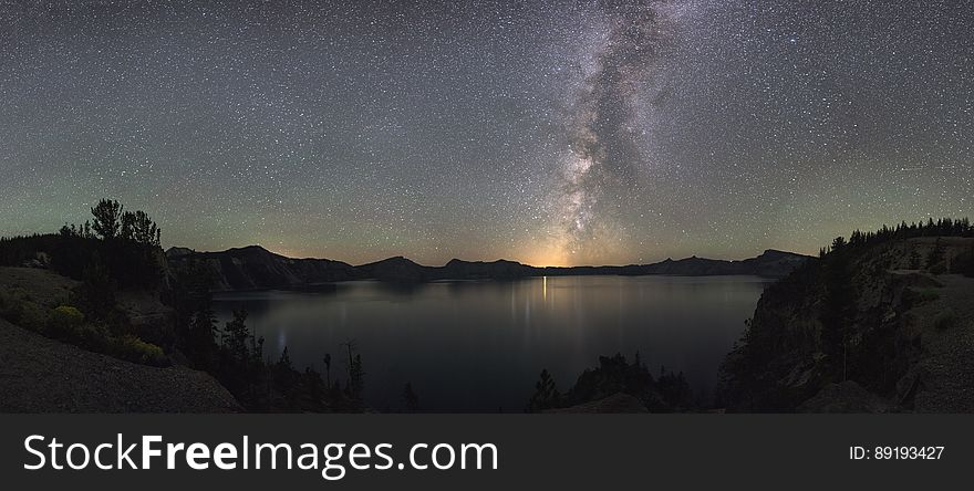 Starry night sky over Crater Lake National Park in Oregon, USA.