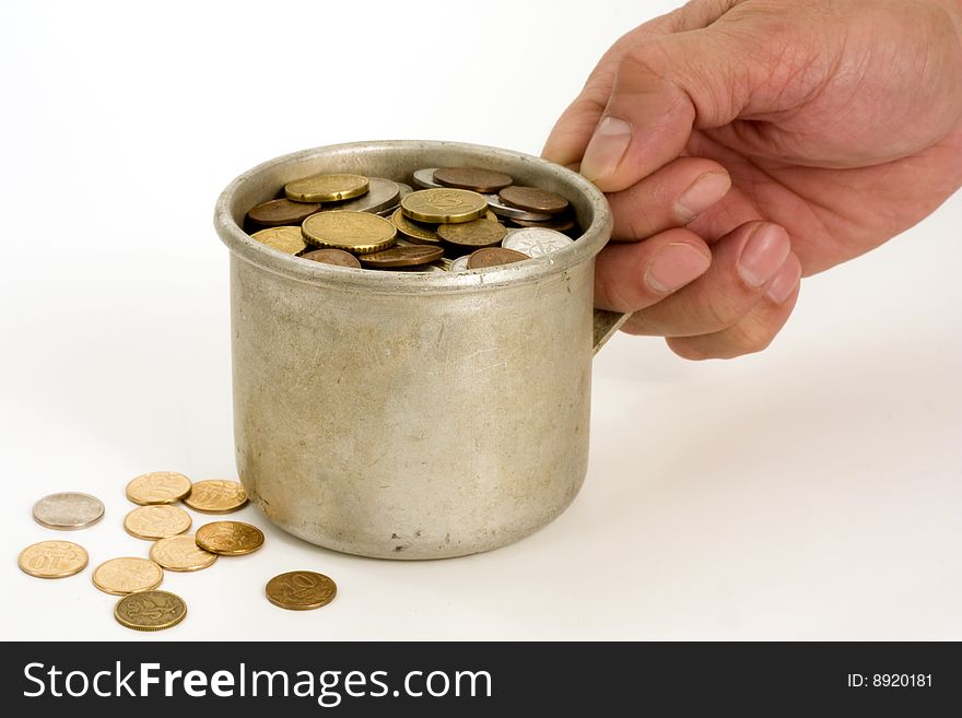 The Male hands and aluminum mug with money. The Male hands and aluminum mug with money.