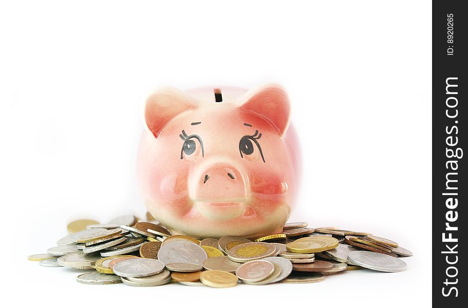 Pink piggy bank isolated on white background with coins