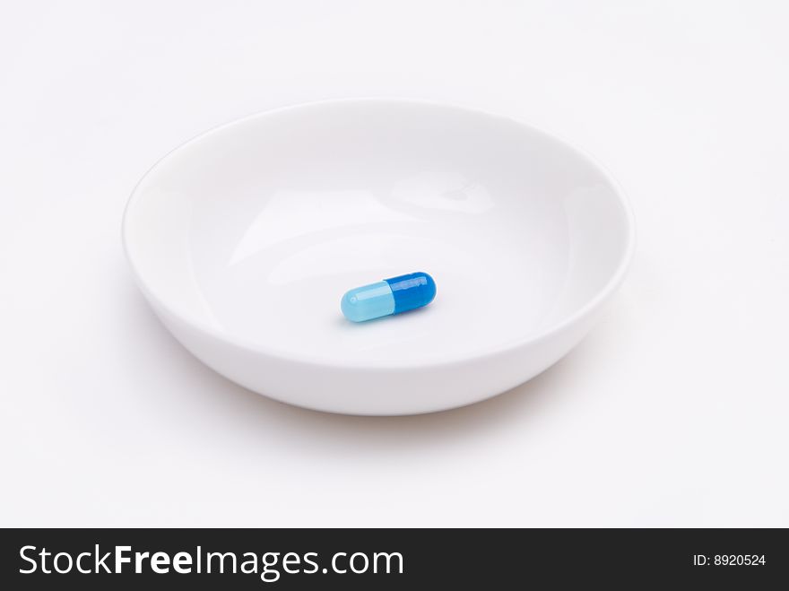 Blue pill on a plate