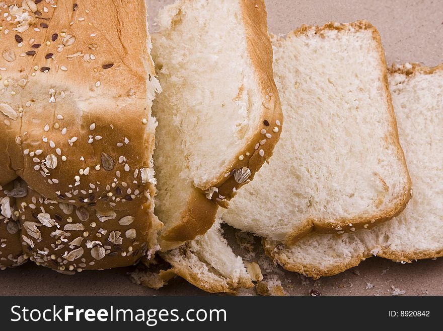 White background, bread in peieces, covered with til seed, cornmeal. White background, bread in peieces, covered with til seed, cornmeal