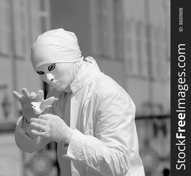 A suggestive monochrome image of a mime with the peace dove