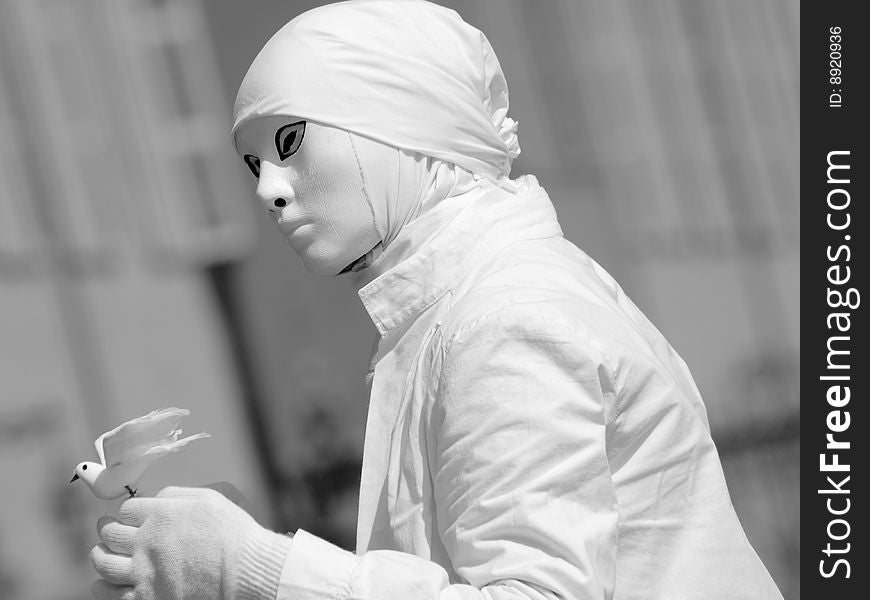 A suggestive monochrome image of a mime with the peace dove