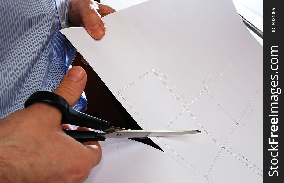 Cutting of shape drawn on a sheet of cardboard. Cutting of shape drawn on a sheet of cardboard