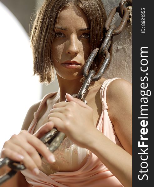 Portrait of young woman with chain near the sea-front. Portrait of young woman with chain near the sea-front