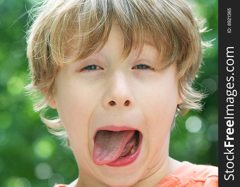 A sweet little boy makes cute grimaces