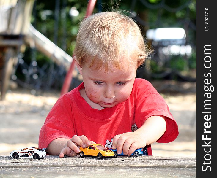 A sweet boy is playing on the playground